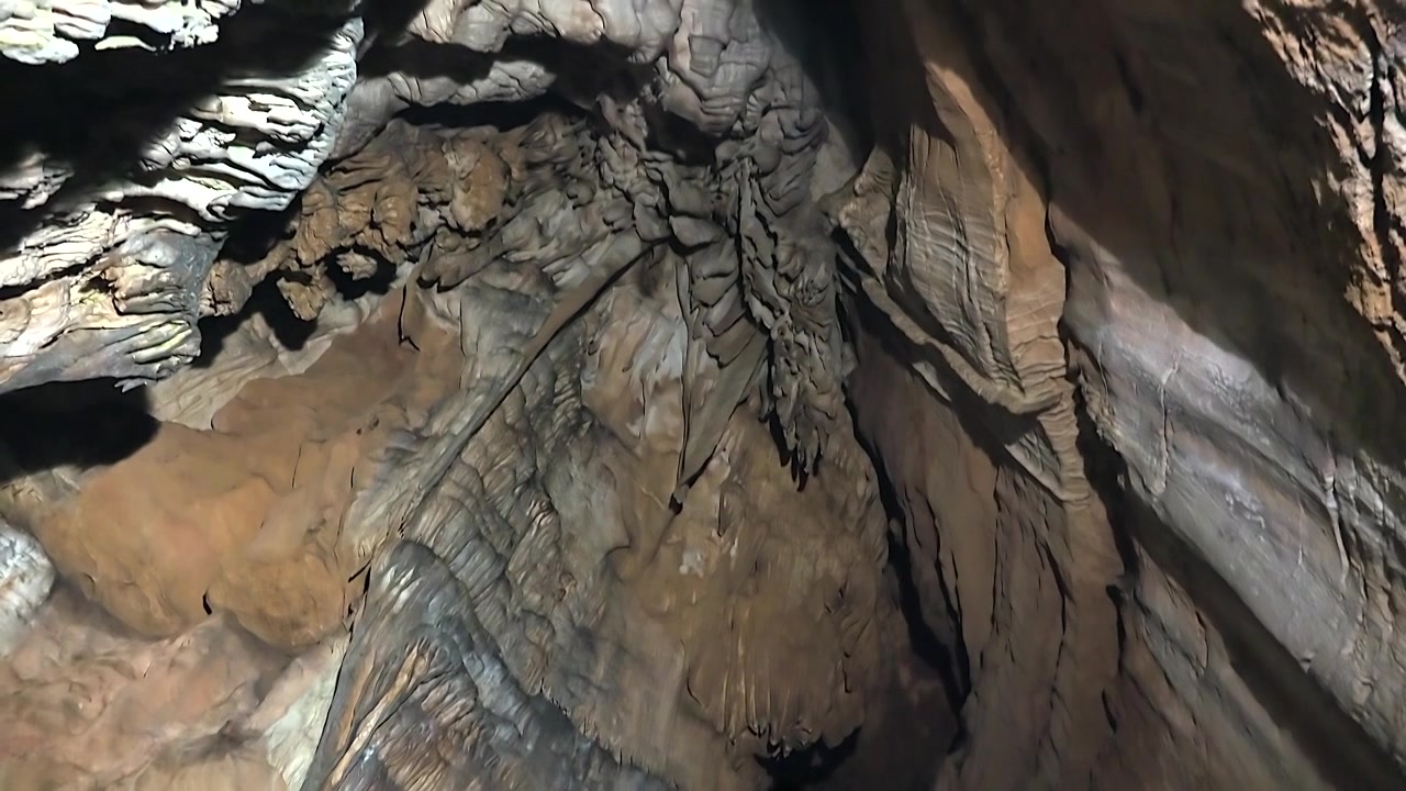Stalactites and Rock Formations Inside a Deep Limestone Cave