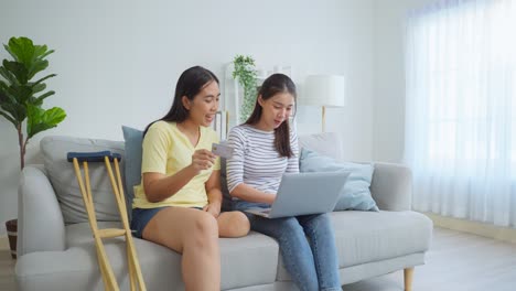 friends shopping online together with one having a disability