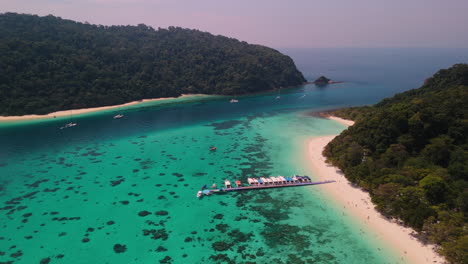 tropical island paradise with coral reef and boats