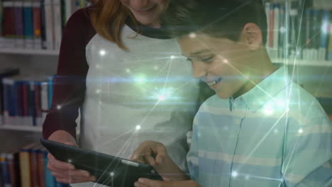 animation of network of connections over diverse female teacher and schoolboy using tablet