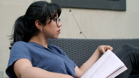 a young latina woman studies while jamming out to music