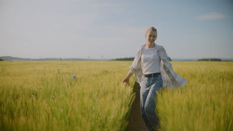 Happy Woman Walks Among Fields of Wheat Grain Enjoying Life