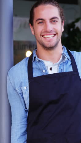 waiter standing outside the cafe