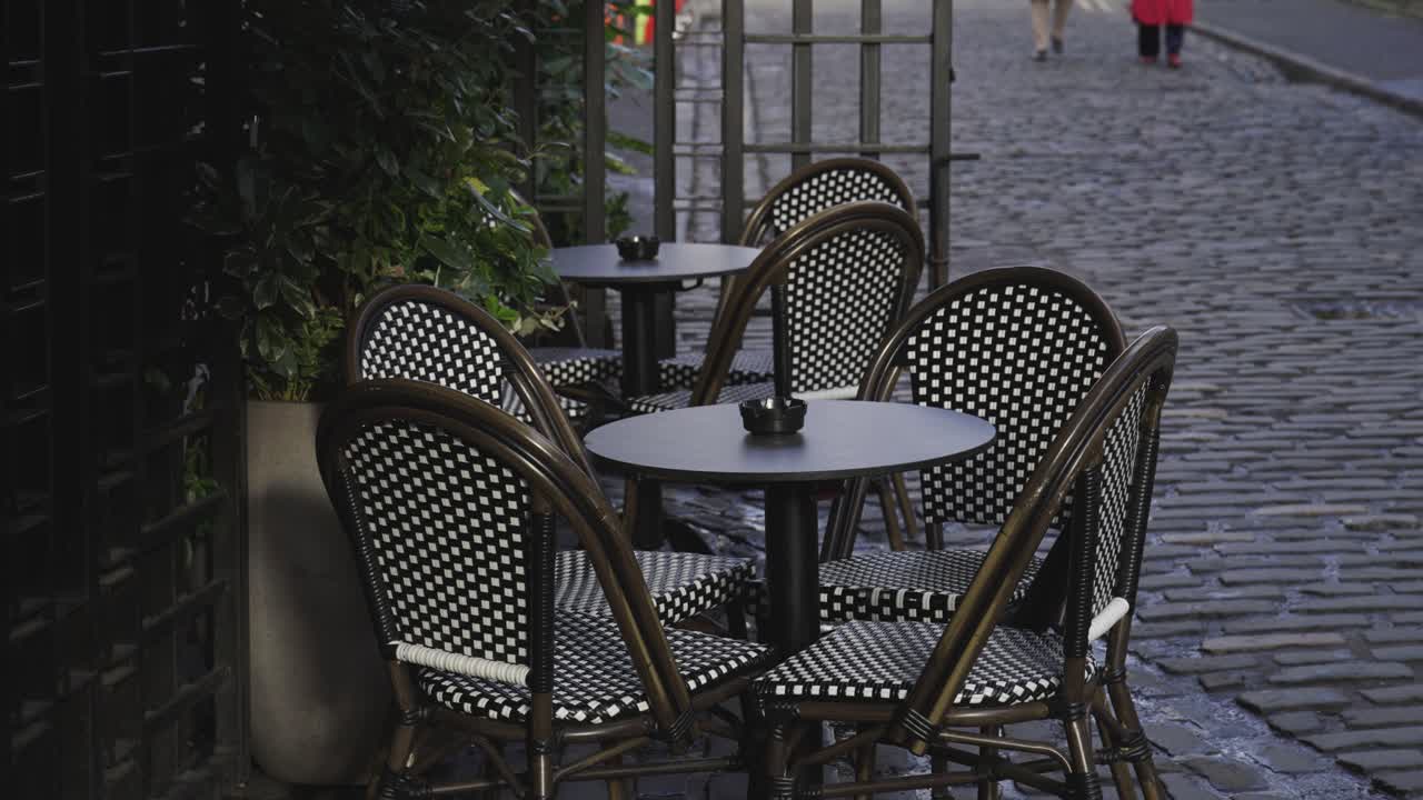 French Style Chairs Sitting Outside A Restaurant Empty On A Cobbled Road