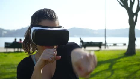 athletic young woman boxing in virtual reality