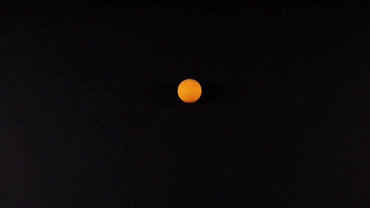 Orange ball moves across a dark background