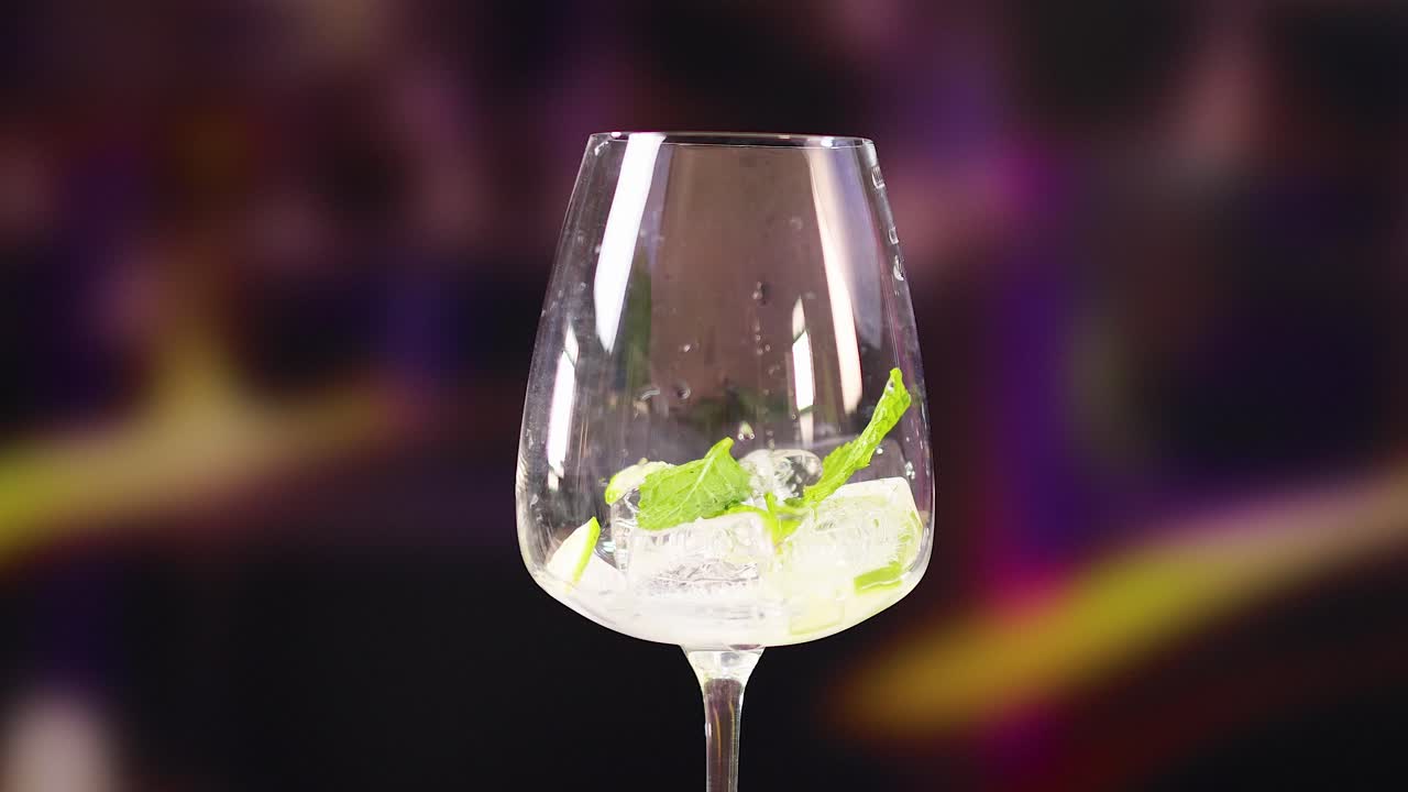A sequence of images showing a mojito cocktail in a glass with lime and mint, set against a vibrant background