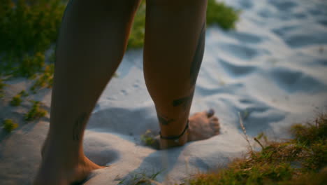 an unrecognizable woman walking barefoot