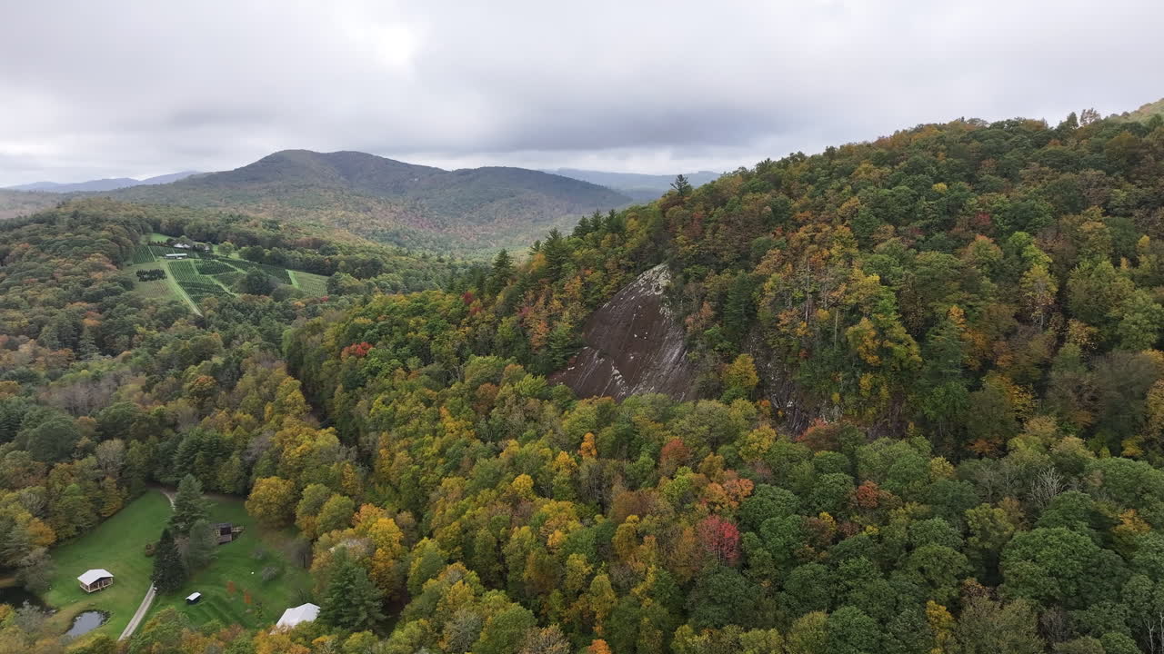 Cinematic drone shot of autumn colors painting the ridges and valleys of North Carolina’s Blue Ridge Mountains