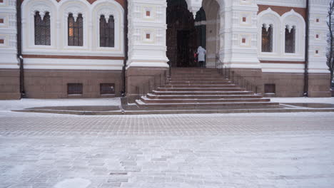 Woman-climbing-stairs-to-Alexander-Nevsky-Cathedral-in-Tallinn,-Estonia