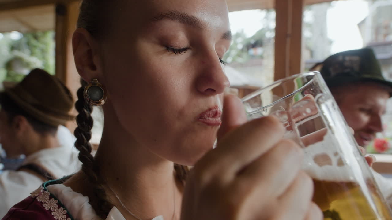 Woman drinking beer at Oktoberfest