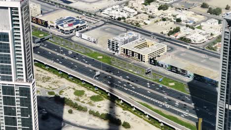 slow motion shot looking over sheik zayed road with the shadow of the burj khalifa on the road in dubai