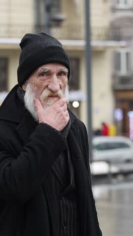 portrait of an elderly man with a beard in winter clothing