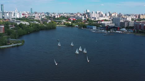 cityscape with sailing boats on a river