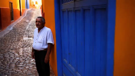 elderly man in a colorful alley