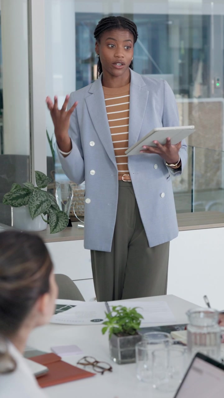 Professional Businesswoman Presenting Ideas to Colleagues in Modern Office