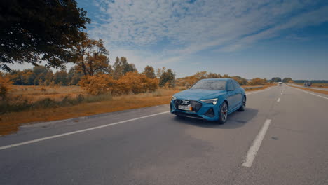 audi e-tron car moving on road. audi e-tron new electric sports car on road