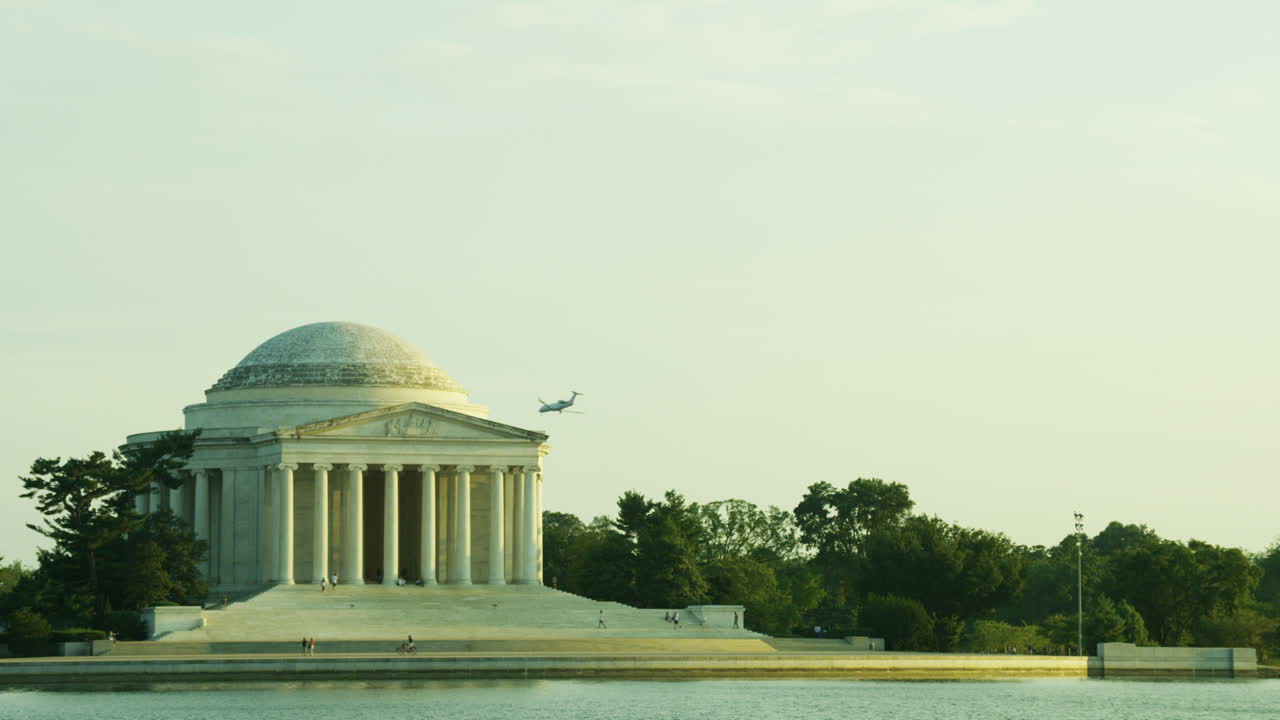 Thomas Jefferson Memorial with an airplane in background.
