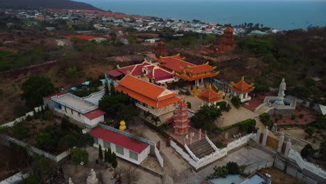 Aerial-drone-view-of-asian-Buu-Son-precious-buddhist-temple-at-dusk