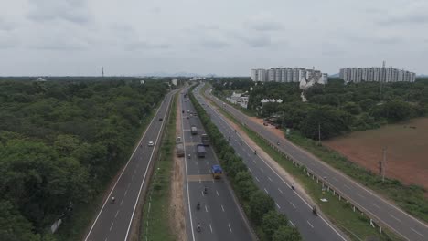 aerial view of highway with traffic and cityscape