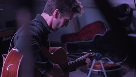 musician tuning guitar on stage before festival