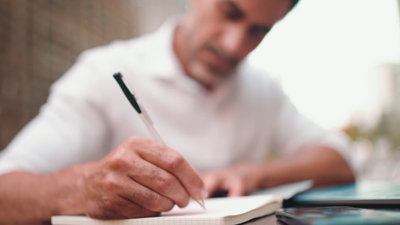 Man writing in notebook