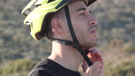 closeup of biker on holiday wears yellow helmet on sunny day, sardinia