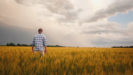 Farmer-Admires-A-Field-Of-Wheat-At-Sunset-3