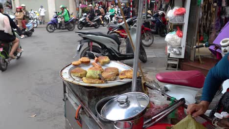 vendor cooking amidst busy street traffic