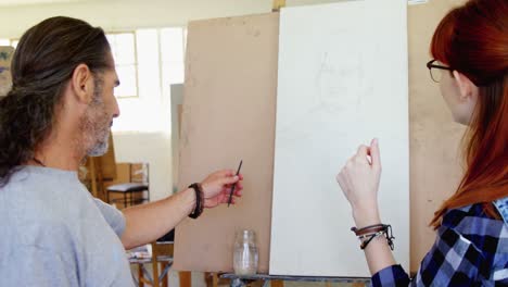 drawing teacher assisting woman on sketch 4k