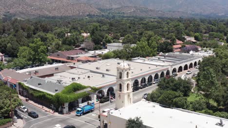Descending-close-up-aerial-shot-of-the-bell-tower-of-the-old-post-office-in-downtown-Ojai,-California