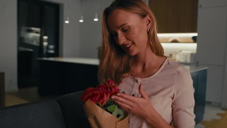 caucasian woman holding a bunch of red roses