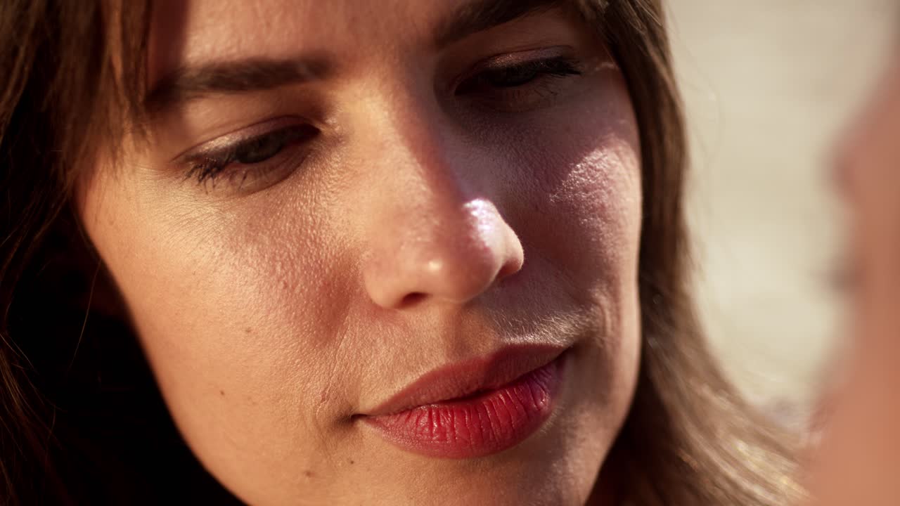 The Woman Gently Strokes the Man's Hair as She Gazes at Him Lovingly - Close Up