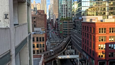 cta train moving in middle of buildings at the s curve, w kinze street in chicago