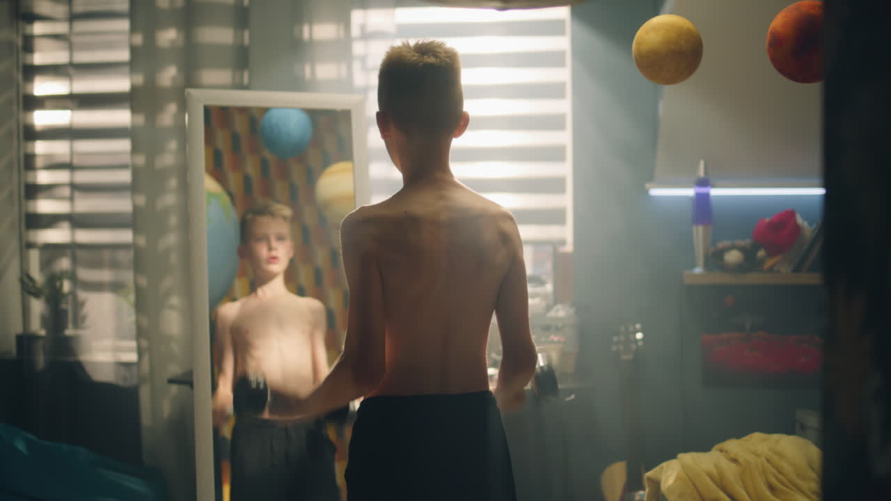 Boy working out in bedroom