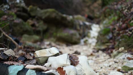 abandoned old car tyre with stuck stones in the woods, close up shot