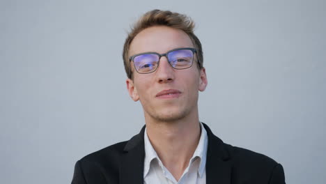 young caucasian male face looking at camera, laughing, talking
