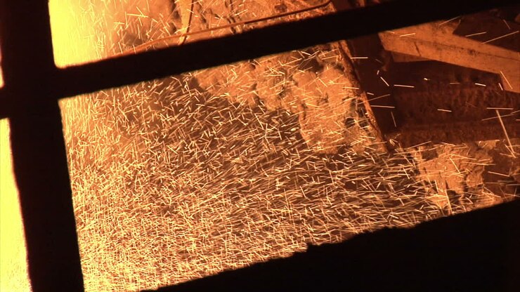 Hot metal sparks from blast furnace. Fire sparks. Sparks of molten metal furnace