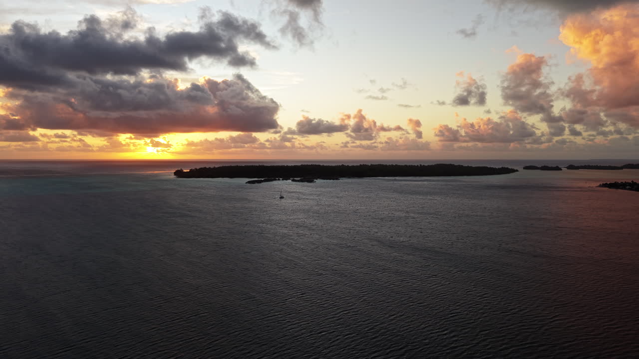 Bora Bora, French Polynesia. Aerial View of Sunset and Clouds Above Lagoon and South Pacific Ocean