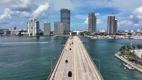 miami’s venetian causeway stretches over biscayne bay with high-rise condos in the distance