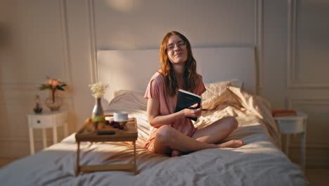 calm girl writing notebook in cozy home interior. romantic female hugging diary