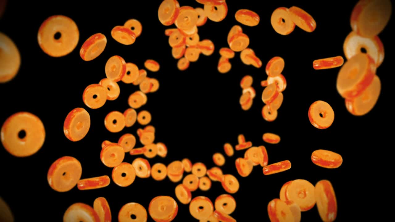 volando muchas rosquillas planas en fondo negro. pastel de rosquillas, dulces, postre. animación en 3d de la rotación de las rosquillas. animación de bucle.