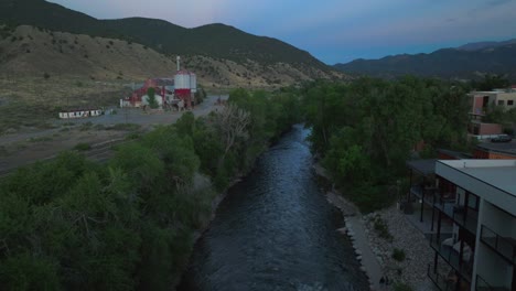 aerial cinematic drone sunset dusk evening down river summer downtown salida colorado buena vista arkansas river riverside park scout surfing biking hiking rafting rocky mountain forward motion