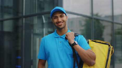 smiling delivery person with yellow bag