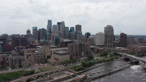 wide reverse pullback aerial shot of downtown minneapolis, minnesota along the mississippi river