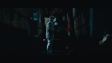 a man in hat in the empty gypsy circus camp at night
