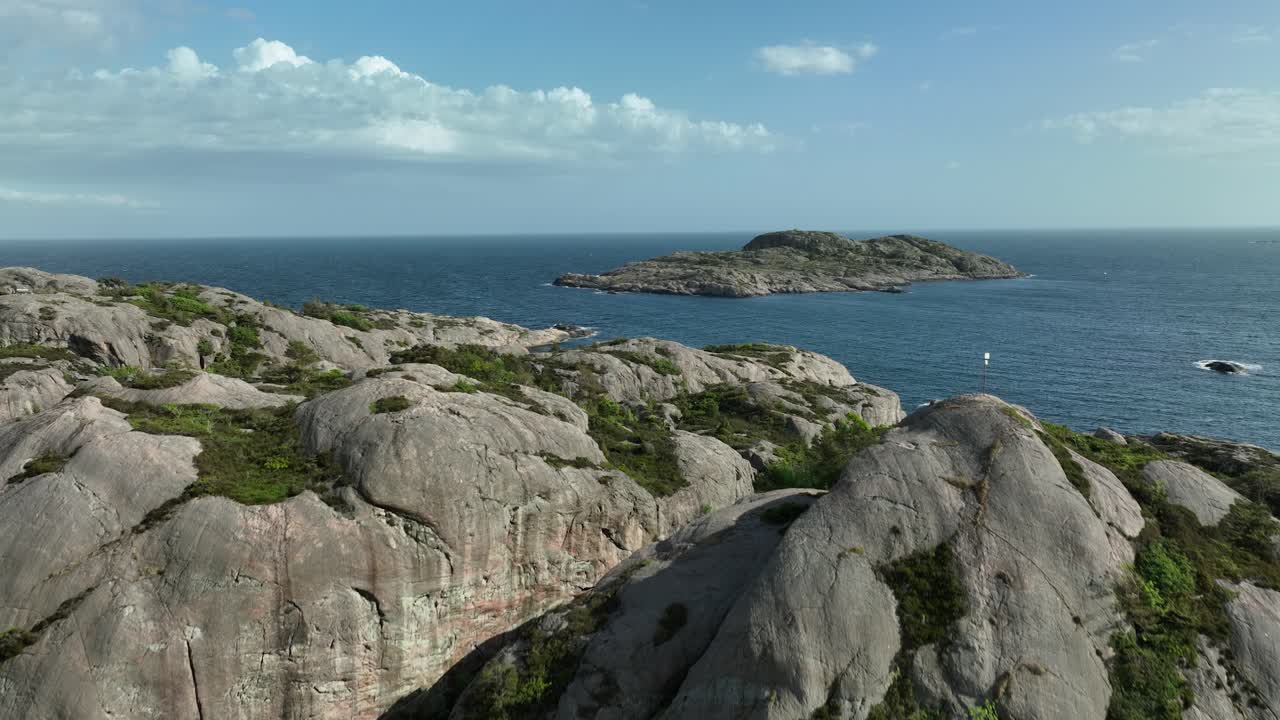 Low drone shot along the coast with boats nearby. Showing Verftet