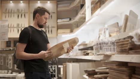 man shopping for cutting boards at furniture store