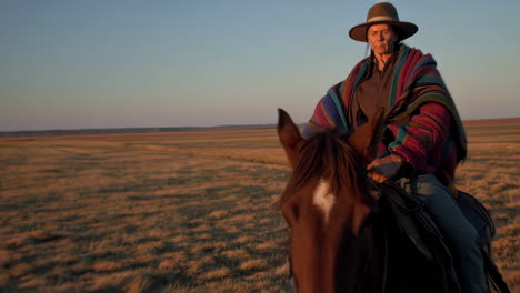 woman in hat and colorful shawl at golden hour