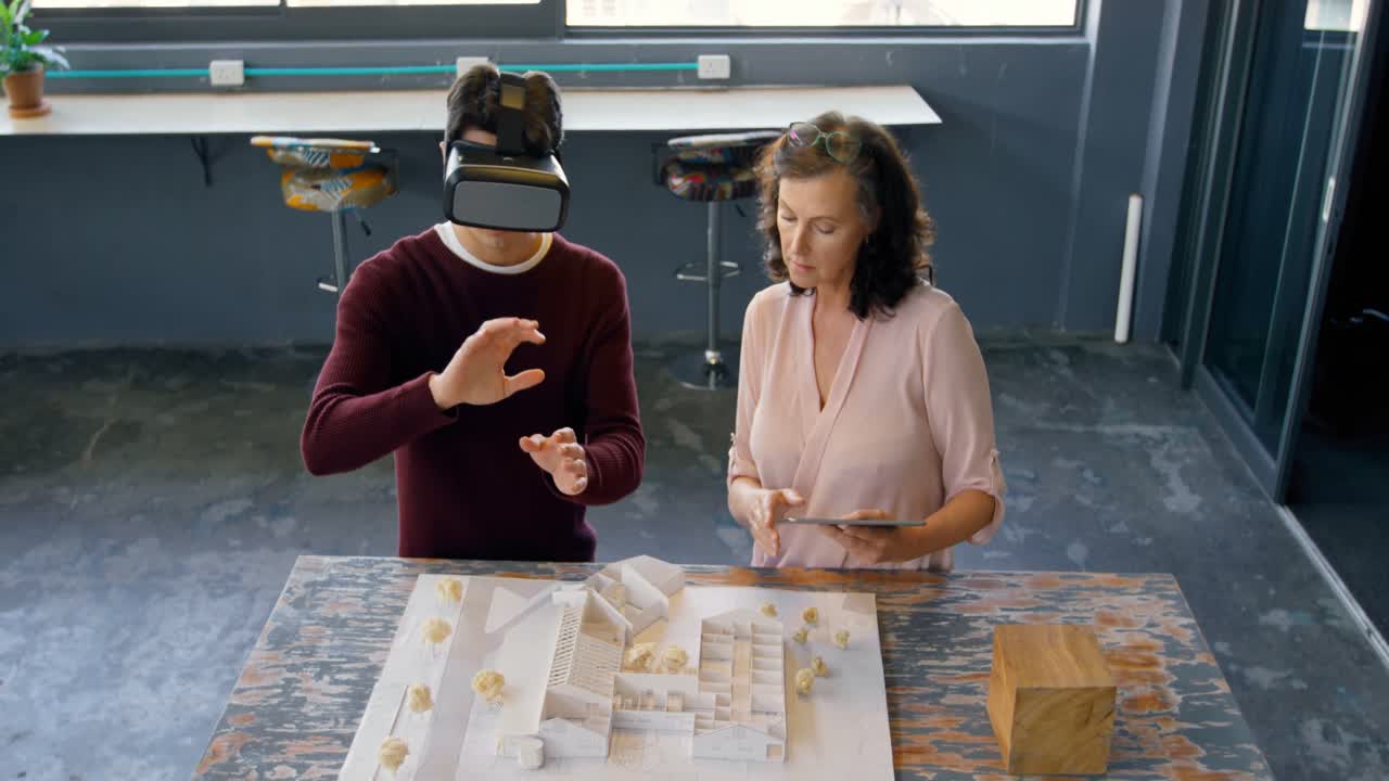ejecutivos que usan tabletas digitales y auriculares de realidad virtual mientras discuten sobre el modo arquitectónico
